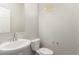 Clean half bathroom featuring pedestal sink, toilet, small window, and neutral paint at 7733 Rosebark Cliffs St, North Las Vegas, NV 89084