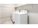 Bright laundry room includes new washer, dryer, and storage shelf at 7733 Rosebark Cliffs St, North Las Vegas, NV 89084
