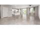 Open living area with tile flooring, a modern kitchen, and access to the backyard through sliding glass doors at 7733 Rosebark Cliffs St, North Las Vegas, NV 89084