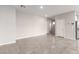 Bright living area with tile flooring, neutral walls, and access to other rooms in the house at 7733 Rosebark Cliffs St, North Las Vegas, NV 89084