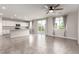 Open living area with a ceiling fan, tile floors, and a view of the backyard at 7733 Rosebark Cliffs St, North Las Vegas, NV 89084