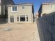 A spacious, unfinished backyard of a two-story home with gray block wall fence at 8116 Russell Creek Ct, Las Vegas, NV 89139
