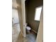 Cozy half bathroom featuring a toilet and a window, conveniently located near the entrance at 8116 Russell Creek Ct, Las Vegas, NV 89139