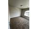 Bedroom with neutral carpet, paint, and trim and large window at 8116 Russell Creek Ct, Las Vegas, NV 89139
