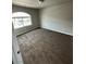 Bedroom with neutral carpet, paint, and trim and large window at 8116 Russell Creek Ct, Las Vegas, NV 89139