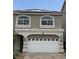 Two-story home featuring a two-car garage and a charming facade with arched windows and solar panels at 8116 Russell Creek Ct, Las Vegas, NV 89139