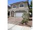 Inviting two-story home featuring a two-car garage and neatly landscaped front yard at 8116 Russell Creek Ct, Las Vegas, NV 89139