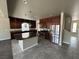 Spacious kitchen featuring a central island, stainless steel appliances, and dark wood cabinetry at 8116 Russell Creek Ct, Las Vegas, NV 89139