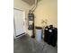 A utility room features a water heater, water softener system, and a white door at 8116 Russell Creek Ct, Las Vegas, NV 89139