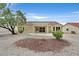 Wide view of the backyard with xeriscaping, patio, and tile roof at 8513 Festival Dr, Las Vegas, NV 89134