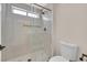 Close-up of a tiled shower with glass doors in a modern bathroom, featuring bronze shower head at 8513 Festival Dr, Las Vegas, NV 89134