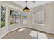 Bright and airy dining area featuring wood-look floors and large windows, perfect for enjoying meals with a view at 8513 Festival Dr, Las Vegas, NV 89134