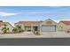 Charming single-story home with a tile roof, desert landscaping, and an attached two-car garage at 8513 Festival Dr, Las Vegas, NV 89134