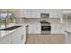 Bright kitchen with stainless appliances, white cabinets, quartz countertops, and modern fixtures at 8513 Festival Dr, Las Vegas, NV 89134