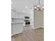 Updated kitchen featuring white cabinets, stainless steel appliances, and modern lighting, enhancing functionality and style at 8513 Festival Dr, Las Vegas, NV 89134