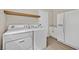 Bright laundry room with wood floors and side-by-side washer and dryer at 8513 Festival Dr, Las Vegas, NV 89134