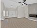 Spacious living room with wood-look floors, a modern fireplace, and vaulted ceilings create an open and inviting atmosphere at 8513 Festival Dr, Las Vegas, NV 89134