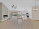 Bright open-concept living area featuring wood-look floors and modern fixtures adjacent to the contemporary kitchen at 8513 Festival Dr, Las Vegas, NV 89134