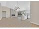 Bright, open-concept living area with fireplace, modern lighting, and access to the kitchen at 8513 Festival Dr, Las Vegas, NV 89134
