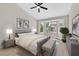 Bright primary bedroom with a vaulted ceiling, fan, and bay window with views of the surrounding neighborhood at 8513 Festival Dr, Las Vegas, NV 89134