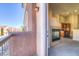 Balcony view into home showing fireplace, kitchen, and exterior neighborhood at 8717 Tom Noon Ave # 101, Las Vegas, NV 89178