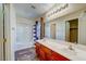 Bright bathroom featuring a double sink vanity, bathtub with shower, and warm lighting at 8717 Tom Noon Ave # 101, Las Vegas, NV 89178