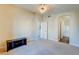 Spacious bedroom with neutral carpet, arched entry, and bathroom access at 8717 Tom Noon Ave # 101, Las Vegas, NV 89178