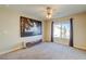 Bedroom features neutral carpet, a ceiling fan, and a window with curtains at 8717 Tom Noon Ave # 101, Las Vegas, NV 89178