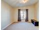 Bedroom features neutral carpet, a ceiling fan, and a window with curtains at 8717 Tom Noon Ave # 101, Las Vegas, NV 89178