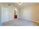 View of carpeted bedroom and doorway to the bathroom with a wood vanity at 8717 Tom Noon Ave # 101, Las Vegas, NV 89178