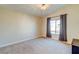 Bedroom features neutral carpet, a ceiling fan, and a window with curtains at 8717 Tom Noon Ave # 101, Las Vegas, NV 89178