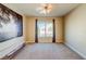 Bedroom features neutral carpet, a ceiling fan, and a window with curtains at 8717 Tom Noon Ave # 101, Las Vegas, NV 89178