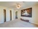 Spacious bedroom with neutral carpet, closet and modern media console at 8717 Tom Noon Ave # 101, Las Vegas, NV 89178