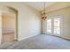 Neutral bedroom features a balcony with natural light and adjoining bath at 8717 Tom Noon Ave # 101, Las Vegas, NV 89178