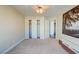 Spacious bedroom with neutral carpet, closet and modern media console at 8717 Tom Noon Ave # 101, Las Vegas, NV 89178