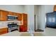 Spacious kitchen with stainless steel appliances, wooden cabinets, and an open design perfect for entertaining and Gathering gatherings at 8717 Tom Noon Ave # 101, Las Vegas, NV 89178