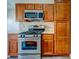 The kitchen features stainless steel appliances, wooden cabinets, and tiled backsplash for a modern culinary experience at 8717 Tom Noon Ave # 101, Las Vegas, NV 89178