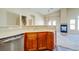 Open-concept kitchen with bar seating flows into a cozy living room with a modern fireplace and ample natural light at 8717 Tom Noon Ave # 101, Las Vegas, NV 89178