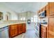 Open kitchen with wood cabinets, stainless steel appliances, and eat-in bar for casual dining at 8717 Tom Noon Ave # 101, Las Vegas, NV 89178
