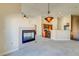 Open floor plan featuring a fireplace, kitchen, and modern lighting fixture at 8717 Tom Noon Ave # 101, Las Vegas, NV 89178