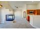 Open living room features a fireplace, ceiling fan, and kitchen access at 8717 Tom Noon Ave # 101, Las Vegas, NV 89178