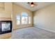 Bright living room featuring a fireplace, neutral paint, and large windows offering views of the neighborhood at 8717 Tom Noon Ave # 101, Las Vegas, NV 89178