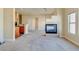 Inviting living room with neutral carpeting, featuring fireplace, cream walls and adjacent kitchen at 8717 Tom Noon Ave # 101, Las Vegas, NV 89178