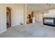 Spacious living room with fireplace, kitchen, and entryway access at 8717 Tom Noon Ave # 101, Las Vegas, NV 89178