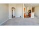 Bright living room with neutral carpeting, cream walls, and an open floor plan leading to kitchen and dining at 8717 Tom Noon Ave # 101, Las Vegas, NV 89178