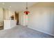 Open loft with modern light fixture and neutral carpeting at 8717 Tom Noon Ave # 101, Las Vegas, NV 89178