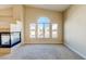 Bright living room featuring fireplace, neutral carpeting, cream walls, and large windows at 8717 Tom Noon Ave # 101, Las Vegas, NV 89178