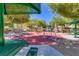 Park and outdoor exercise space with green metal structures and shade at 8717 Tom Noon Ave # 101, Las Vegas, NV 89178