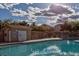 Community pool with a safety fence and small building for storage, perfect for summer relaxation at 8717 Tom Noon Ave # 101, Las Vegas, NV 89178