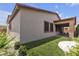 A view of the backyard, featuring synthetic grass and a covered patio at 9570 Thistle Creek Ave, Las Vegas, NV 89178